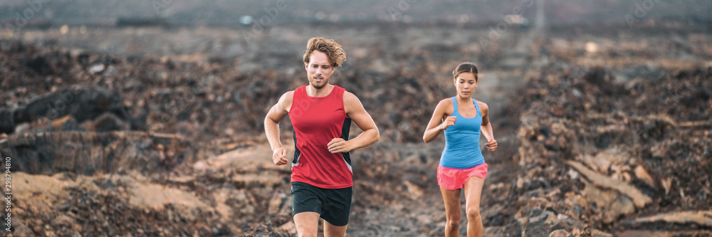 Running couple trail run race competition athletes banner panoramic man and woman athletes training outdoors panorama. Running couple trail run race competition athletes banner panoramic man and woman athletes training outdoors panorama.