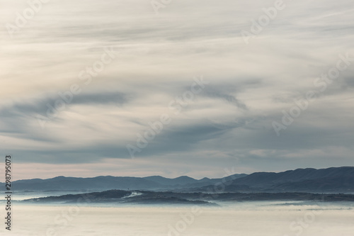 A view of Umbria valley with hills and fog © Massimo