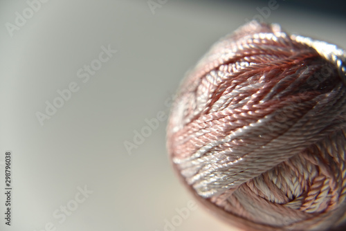 brown and white silk thread on the plain background