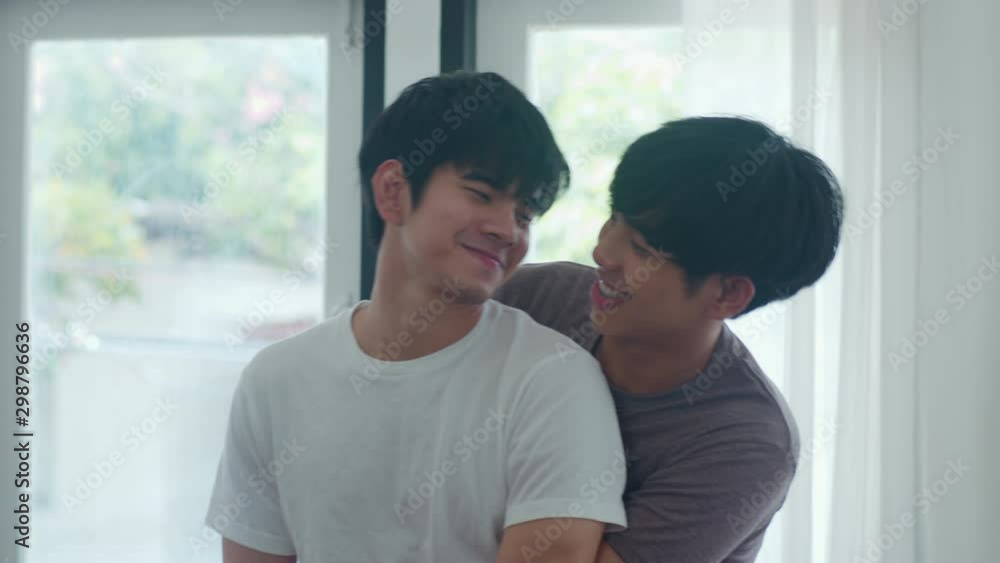 Asian Gay Couple Standing And Hugging Near The Window At Home Young Asian Lgbtq Men Kissing 