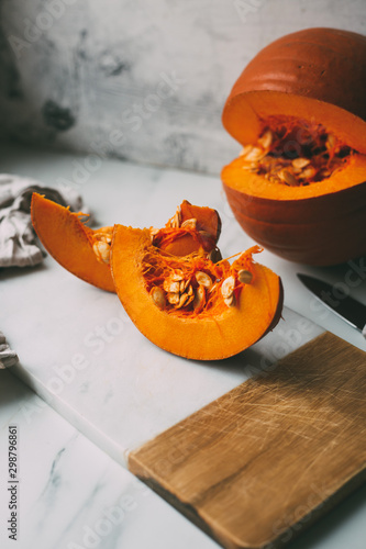 pumpkins with cinnamon sticks on marble backgrund photo