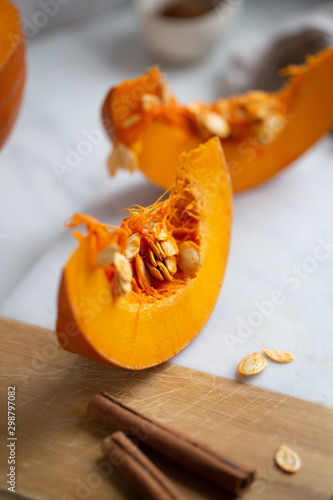 pumpkins with cinnamon sticks on marble backgrund photo