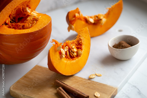 pumpkins with cinnamon sticks on marble backgrund photo