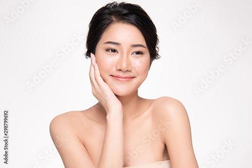 Beautiful young Asian woman touching soft cheek and smile with clean and fresh skin. Happiness and cheerful with, isolated on white background, Beauty and Cosmetics Concept,