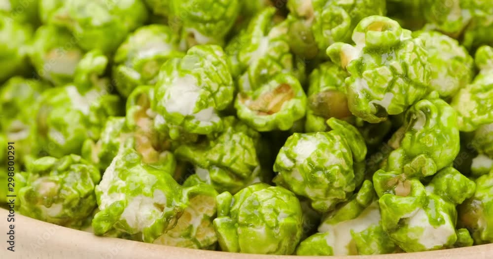 Truck shot of Japanese matcha green tea popcorn in the wooden bowl bulk isolated on white background Truck shot of Japanese matcha green tea popcorn in the wooden bowl bulk isolated on white background