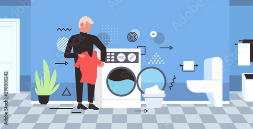 man doing housework guy loading clothes in washing machine cleaning service concept modern bathroom interior horizontal full length sketch vector illustration