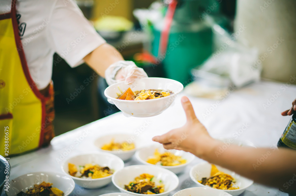 Helping the poor in society by sharing food. Charity : The concept of food donation And food needs Helping the poor in society by sharing food. Charity : The concept of food donation And food needs