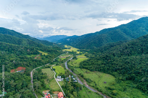 Aerial view drone shot of mountain tropical rainforest,Bird eye view Amazing nature background with clouds and mountain peaks