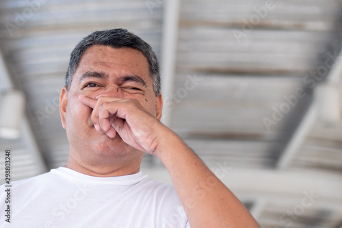 allergic sick old man having cold, flu, allergy with runny nose