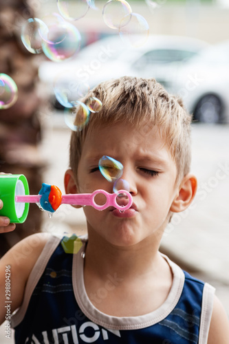 boy blowing soap bubbles