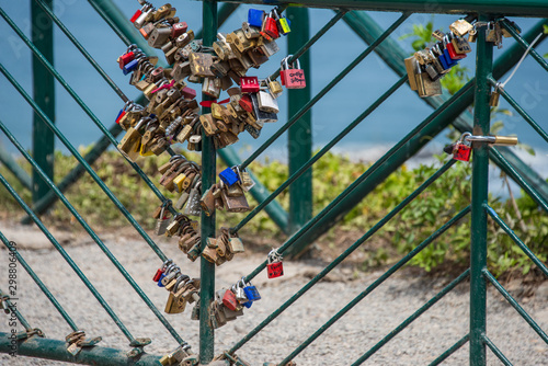 Locks hung by lovers on an iron fence in Parque del Amor in Lima