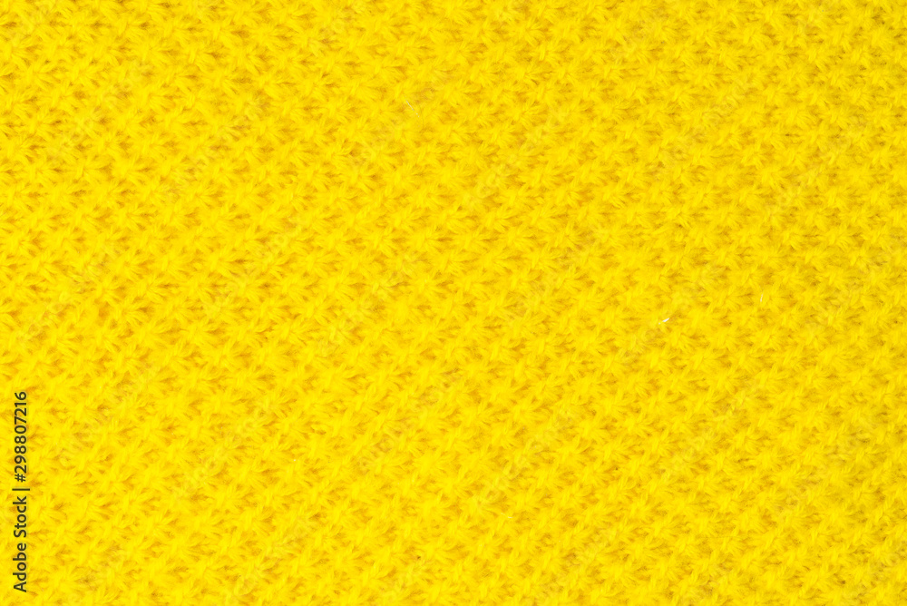 The tail is made of yellow knitted fabric texture. knitting texture close up Photo. orange, yellow knitted background. the texture of the warm fabric. colorful bright wool The tail is made of yellow knitted fabric texture. knitting texture close up Photo. orange, yellow knitted background. the texture of the warm fabric. colorful bright wool