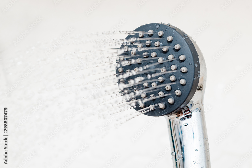 shower faucet with splashing water drops. Water runs from the shower head and tap in the modern