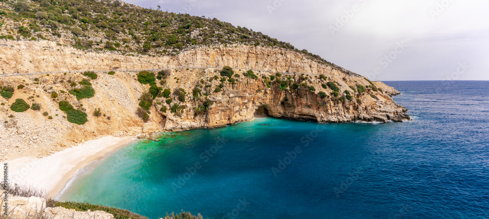 Obraz premium Amazing turquoise beach and cove on the way to Demre - Finike. Detail of cave. Kas, Antalya, Turkey. Summer and holiday background.