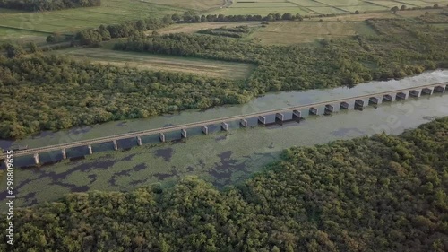 Aerial drone of the historical railway bridge over the Lange Putten peat lake in the nature reserve Moerputten in 4K photo