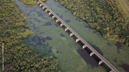 Aerial drone of the historical railway bridge over the Lange Putten peat lake in the nature reserve Moerputten in 4K photo