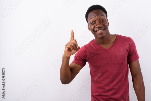 Young handsome African man against white background