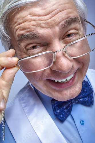 Close up portrait of funny smiling cheerful senior businessman clerk with glasses