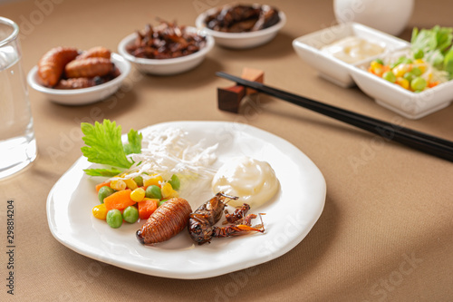 Insect food for fried Worm  Cricket and Grasshopper with vegetable salad in the white bowl. Healthy meal high protein diet concept. Closeup  Selective focus.