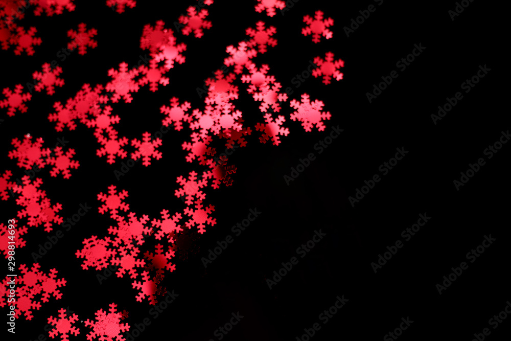 red snowflake glitter sparkle isolated on black background