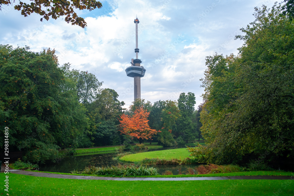 Obraz premium Euromast observation tower in Rotterdam, Netherlands. City park trees and green grass