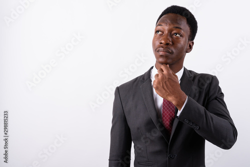 Young handsome African businessman wearing suit against white ba