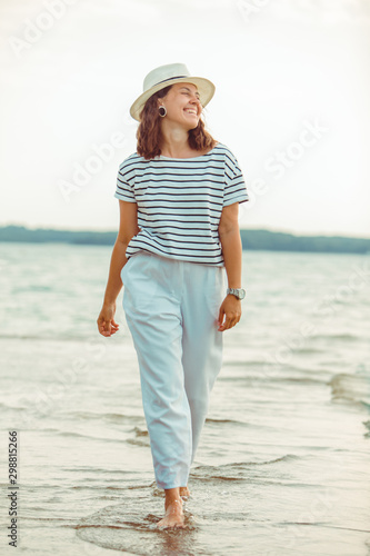 woman in white clothes walking by sea beach