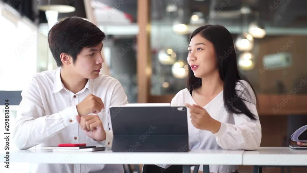 Young business co-worker discussing project at the office. Young business co-worker discussing project at the office.