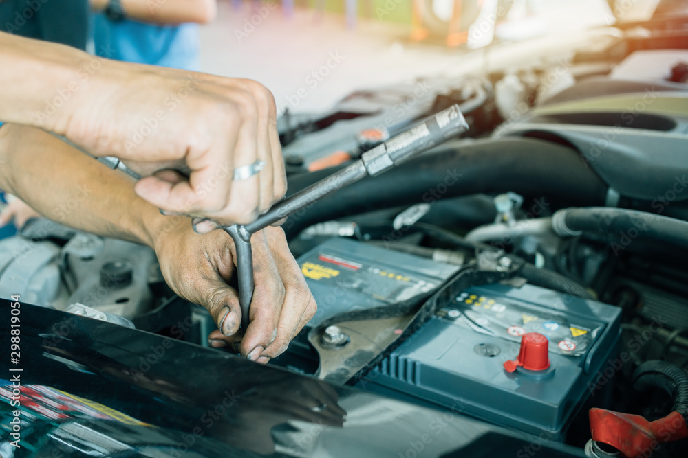 Changing the car battery that does not start. technician man using a  wrench, fitting to spinning screws for the auto battery at Service shop  Stock Photo | Adobe Stock