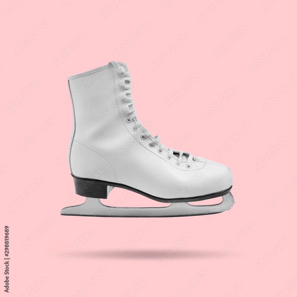 Floating white ice skate on pink background, minimal design Floating white ice skate on pink background, minimal design
