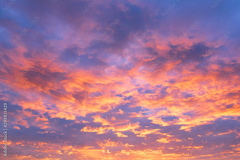Fiery orange sunset sky. Beautiful sky. Beautiful orange clouds on a blue  sunset sky. Stock Photo
