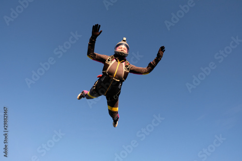 Skydiving. An active woman is flying in the sky.