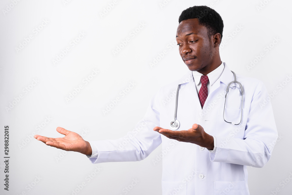 Young handsome African man doctor against white background Young handsome African man doctor against white background