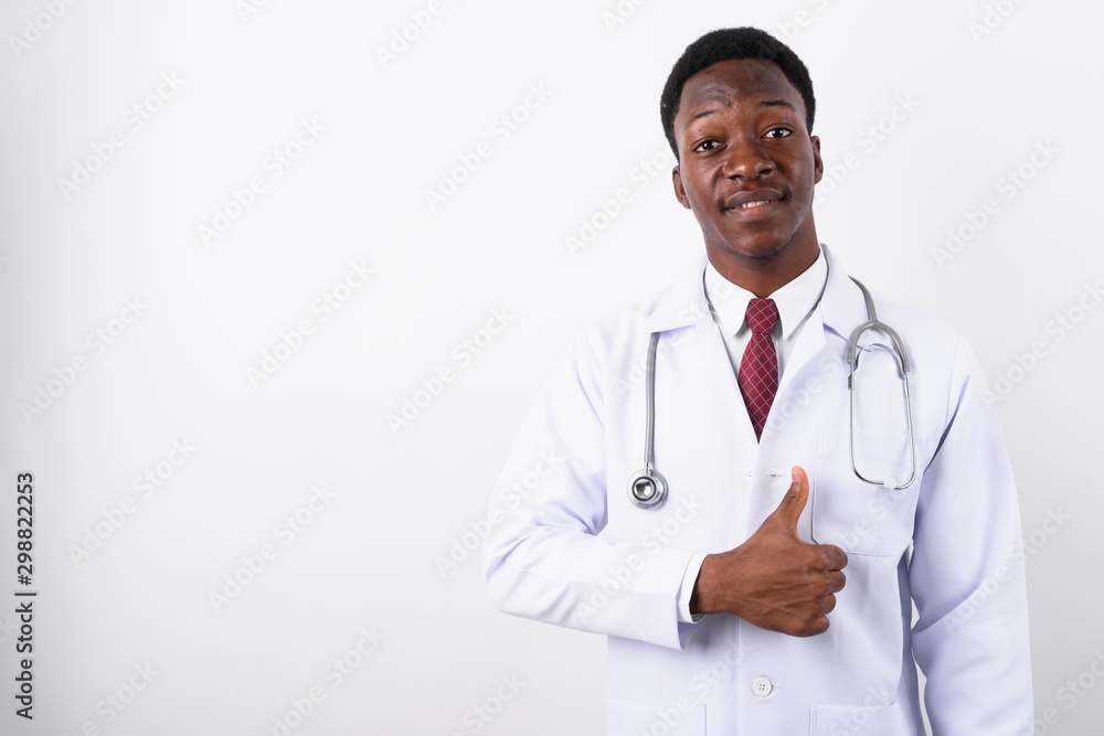 Young handsome African man doctor against white background