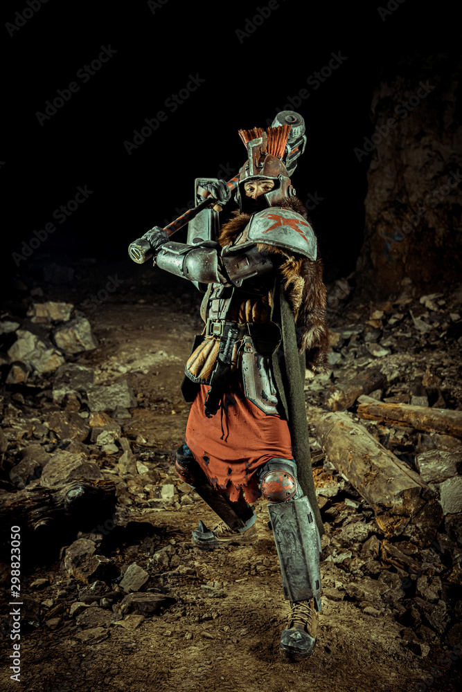 Attack of a powerful knight in the armor with the hammer. Dungeon on the background.