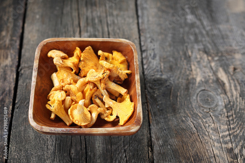 Chanterelles, forest mushrooms on a wooden background