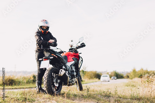 Woman preparing to drive a motorbike. Roadside break