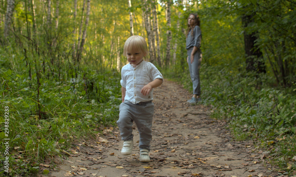 Angry small boy walking along the dirt road Angry small boy walking along the dirt road