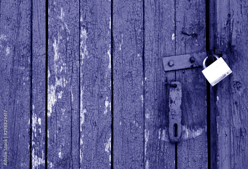 Grungy wooden door with lock in blue tone. Grungy wooden door with lock in blue tone.