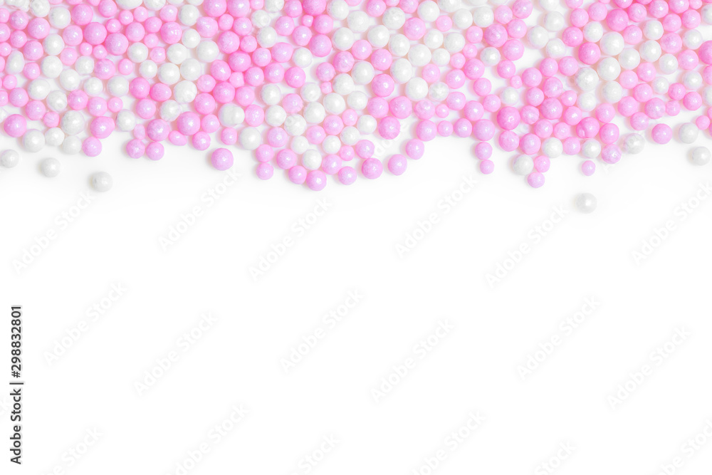 Pink and white sugar pearls on white background
