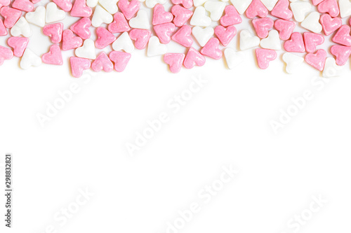 sugar hearts colored white and rose on white background photo