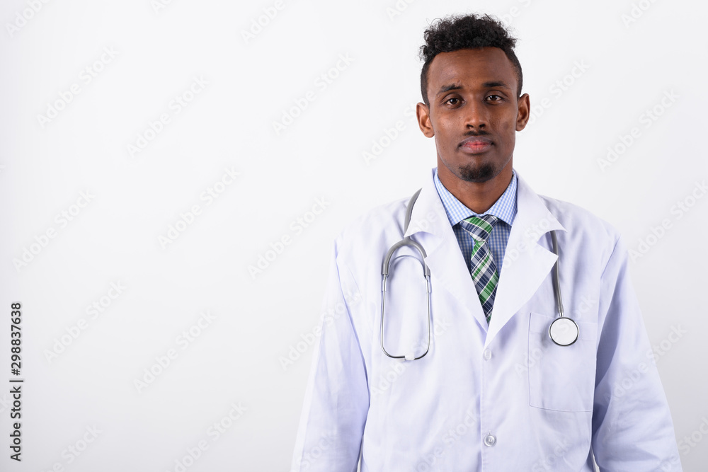 Young bearded African man doctor against white background
