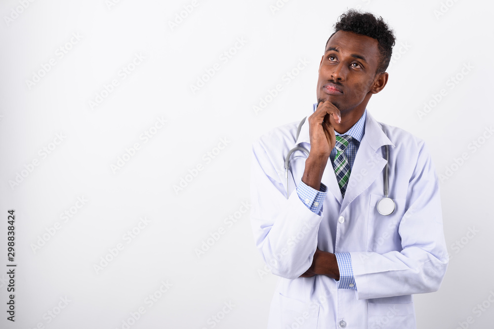 Young bearded African man doctor against white background Young bearded African man doctor against white background
