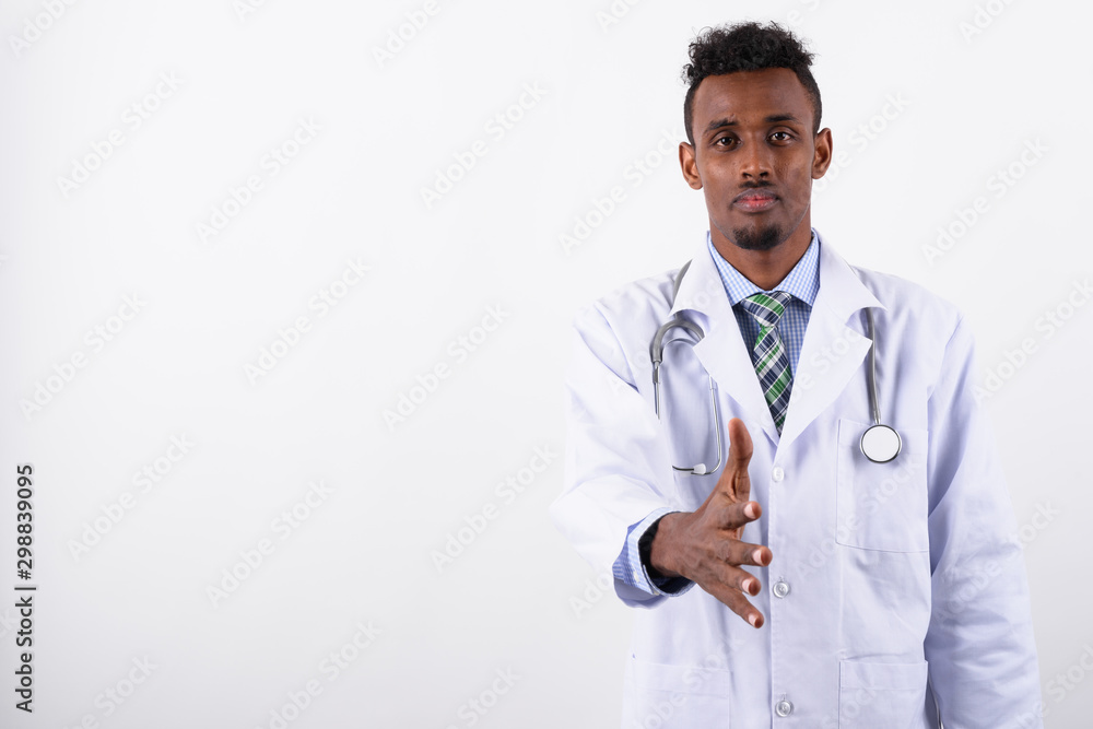 Young bearded African man doctor against white background Young bearded African man doctor against white background