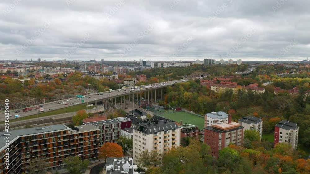 Aerial view of Stockholm highway, panning shot. Drone flies over buildings and traffic. Aerial view of Stockholm highway, panning shot. Drone flies over buildings and traffic.