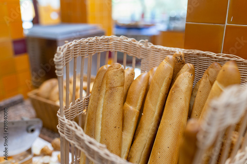 Baguette or french bread are in the wicker basket. People usually eat with butter soup. It is easy breakfast in the morning,organic, healthy concept