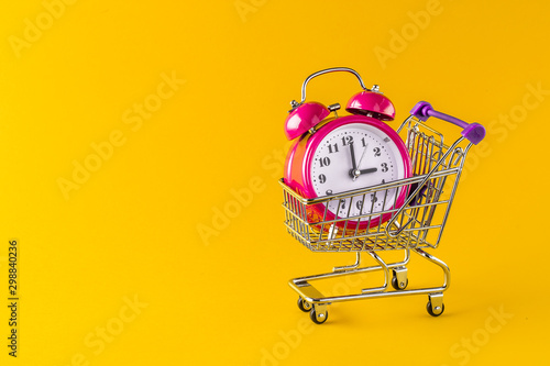 alarm clock and mini trolley cart with space copy photo