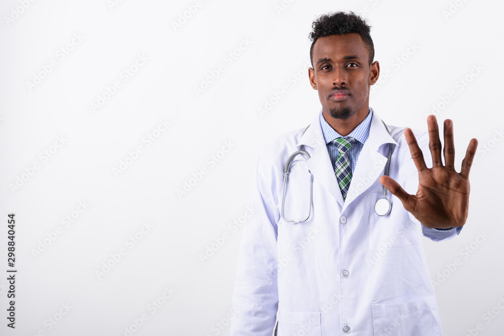 Young bearded African man doctor against white background Young bearded African man doctor against white background