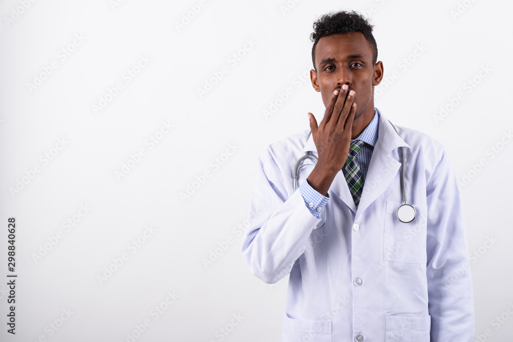 Young bearded African man doctor against white background Young bearded African man doctor against white background