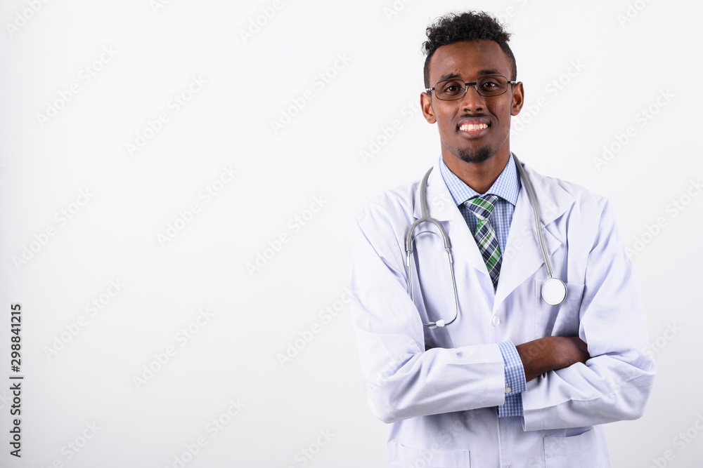 Young bearded African man doctor against white background